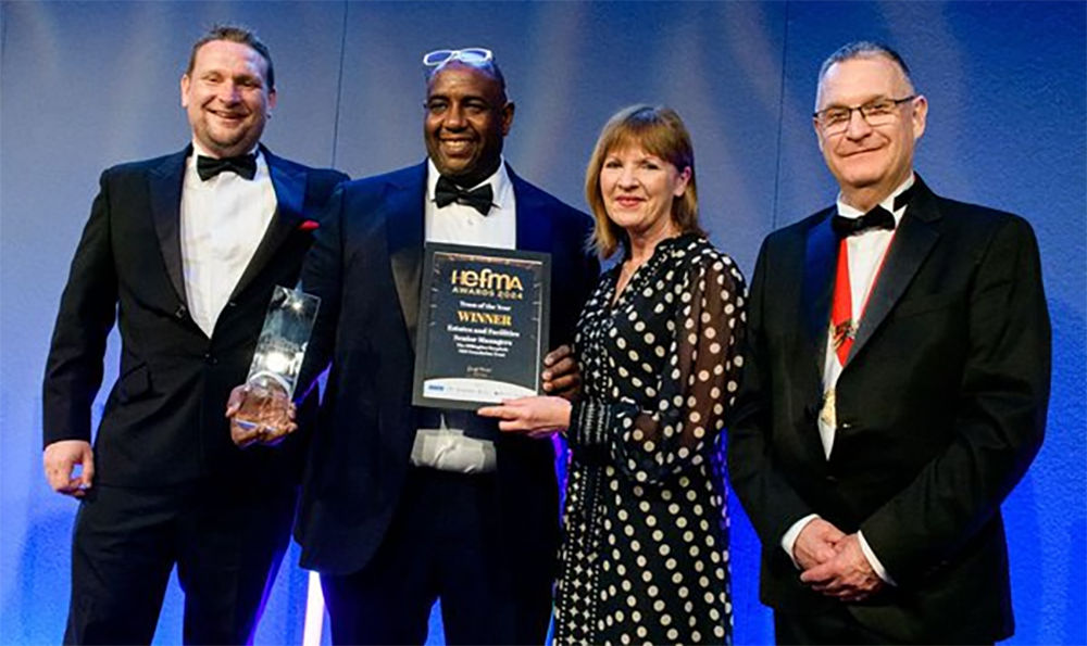 Two members of staff receiving an award